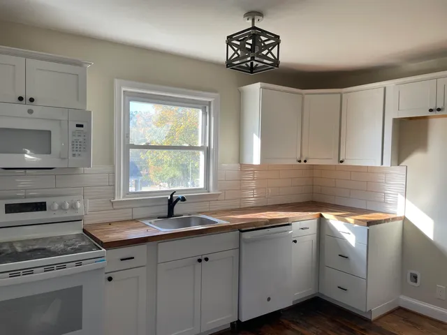 a kitchen with a sink cabinets and window