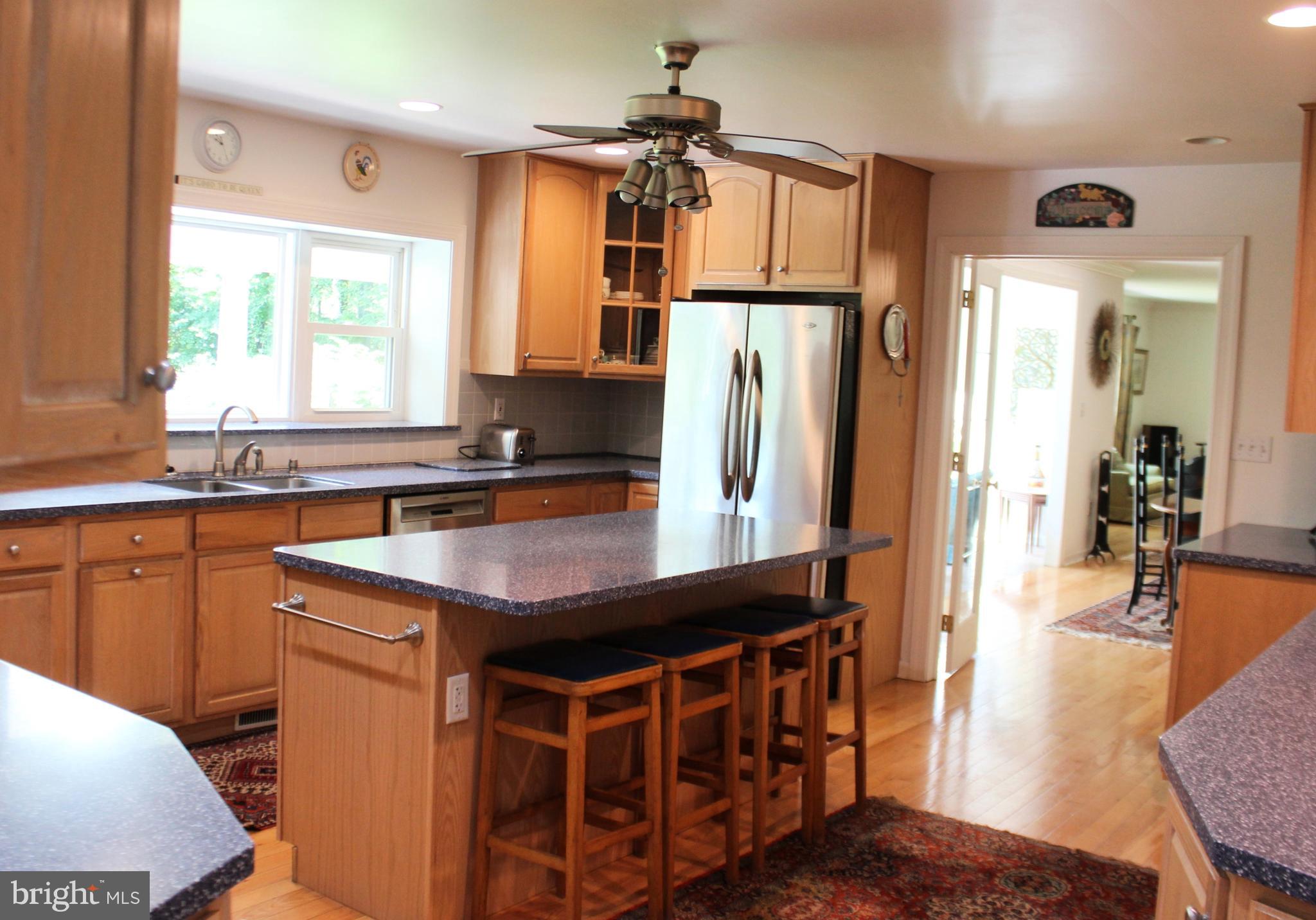 178 Shed Road Douglassville, PA 19518 - Photo 12 of 58 a kitchen with stainless steel appliances kitchen island granite countertop a table chairs in it and a window