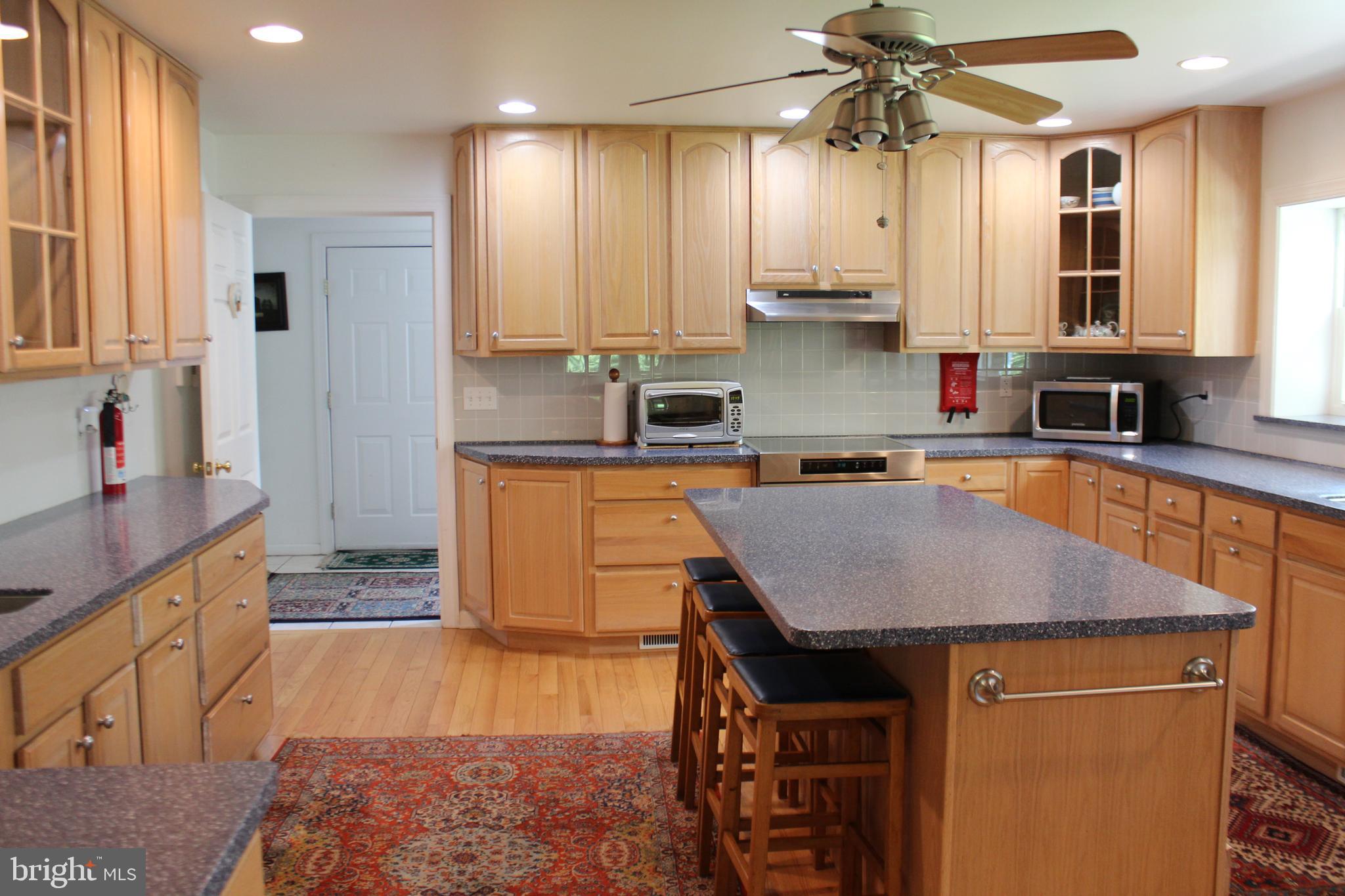 178 Shed Road Douglassville, PA 19518 - Photo 13 of 58 a kitchen with stainless steel appliances granite countertop a stove a sink dishwasher and a refrigerator with wooden floor