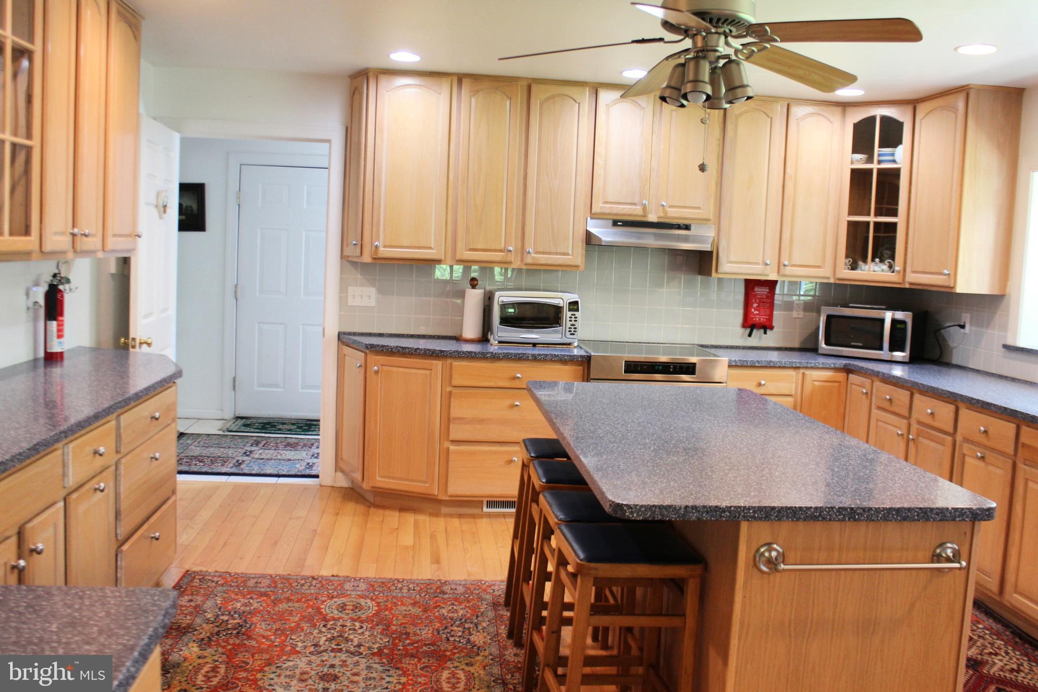 178 Shed Road Douglassville, PA 19518 - Photo 15 of 58 a kitchen with stainless steel appliances granite countertop a stove a sink and a microwave