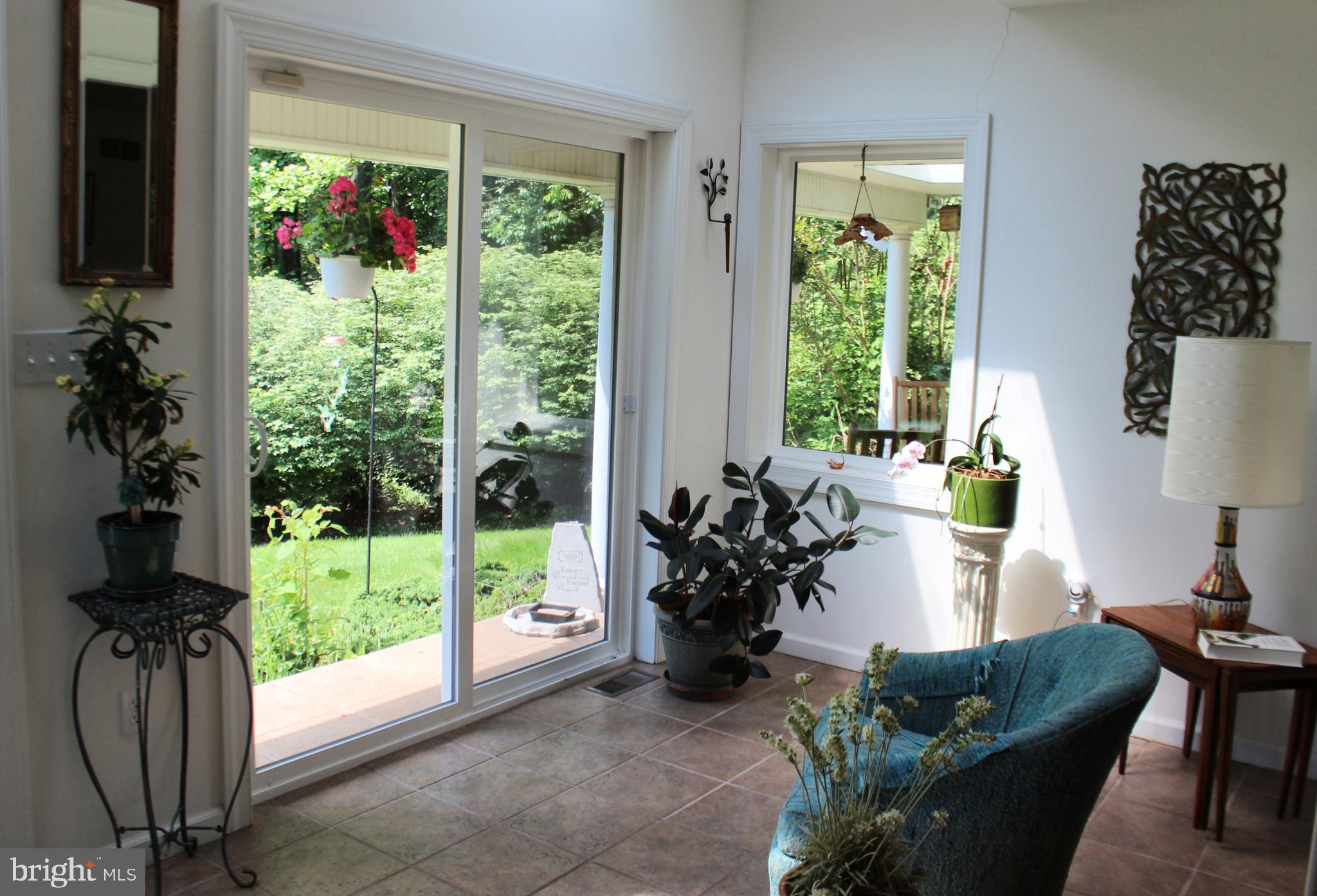 178 Shed Road Douglassville, PA 19518 - Photo 26 of 58 a living room with furniture floor to ceiling window and a potted plant