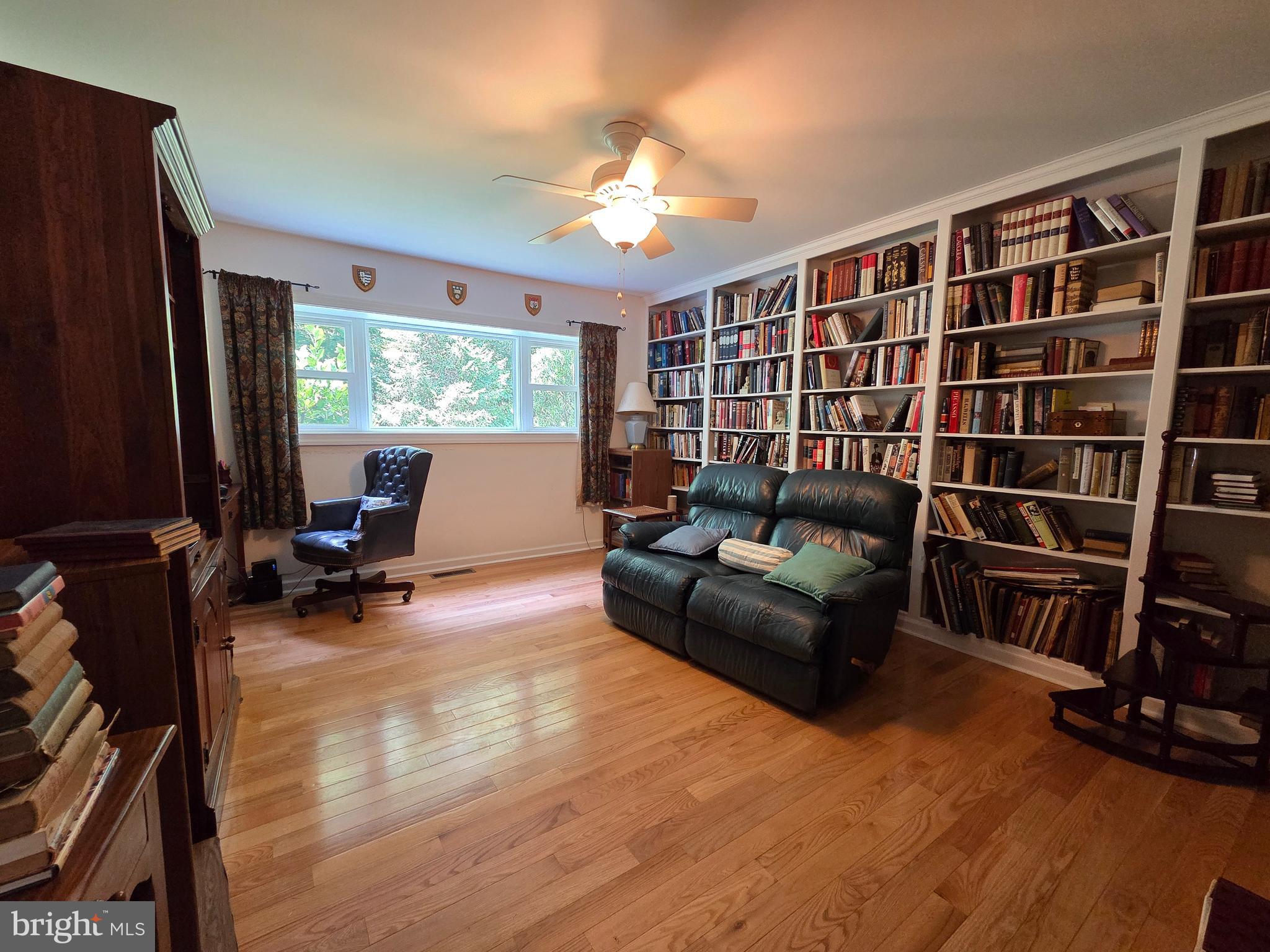 178 Shed Road Douglassville, PA 19518 - Photo 32 of 58 a living room with furniture a large window and bookshelf