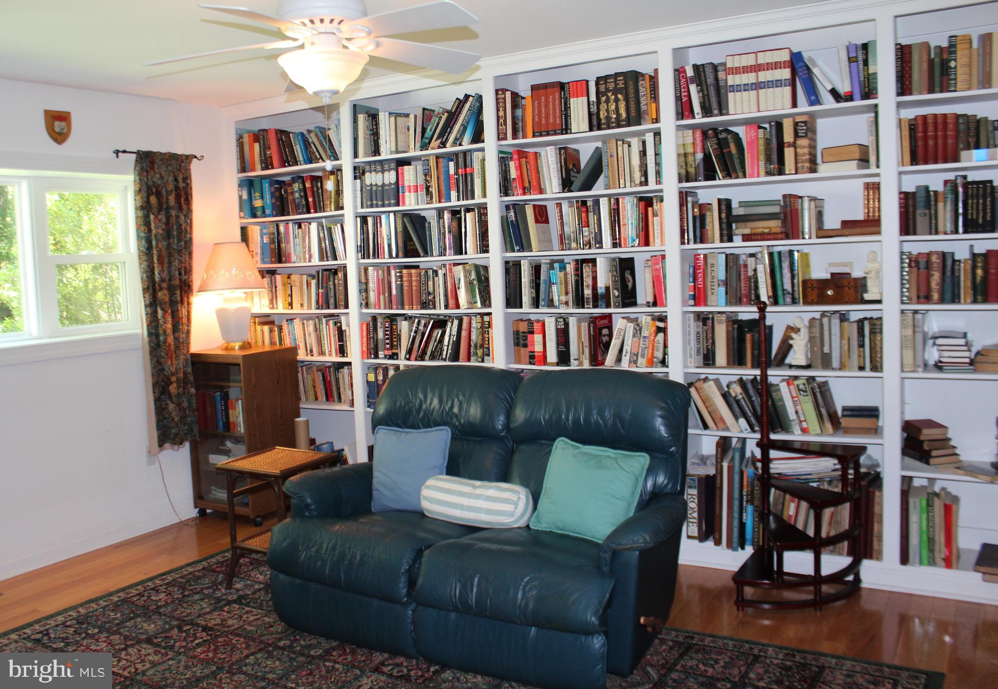 178 Shed Road Douglassville, PA 19518 - Photo 33 of 58 a living room with furniture and a book shelf