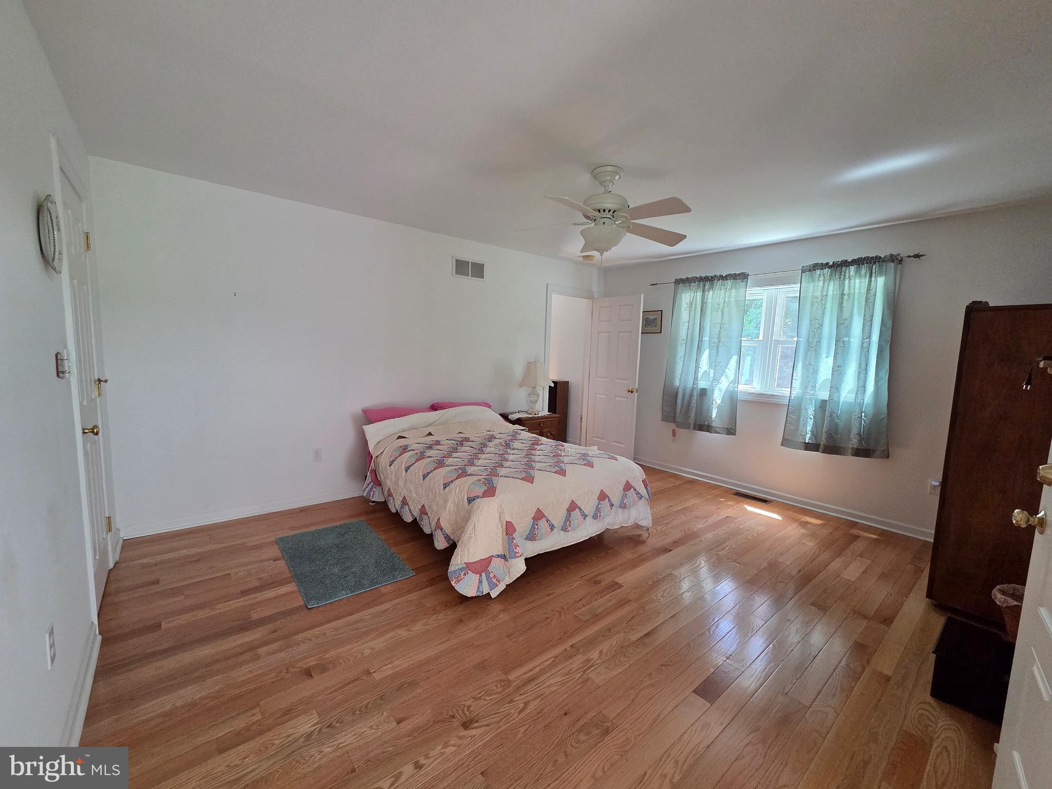178 Shed Road Douglassville, PA 19518 - Photo 42 of 58 a bedroom with a bed and wooden floor