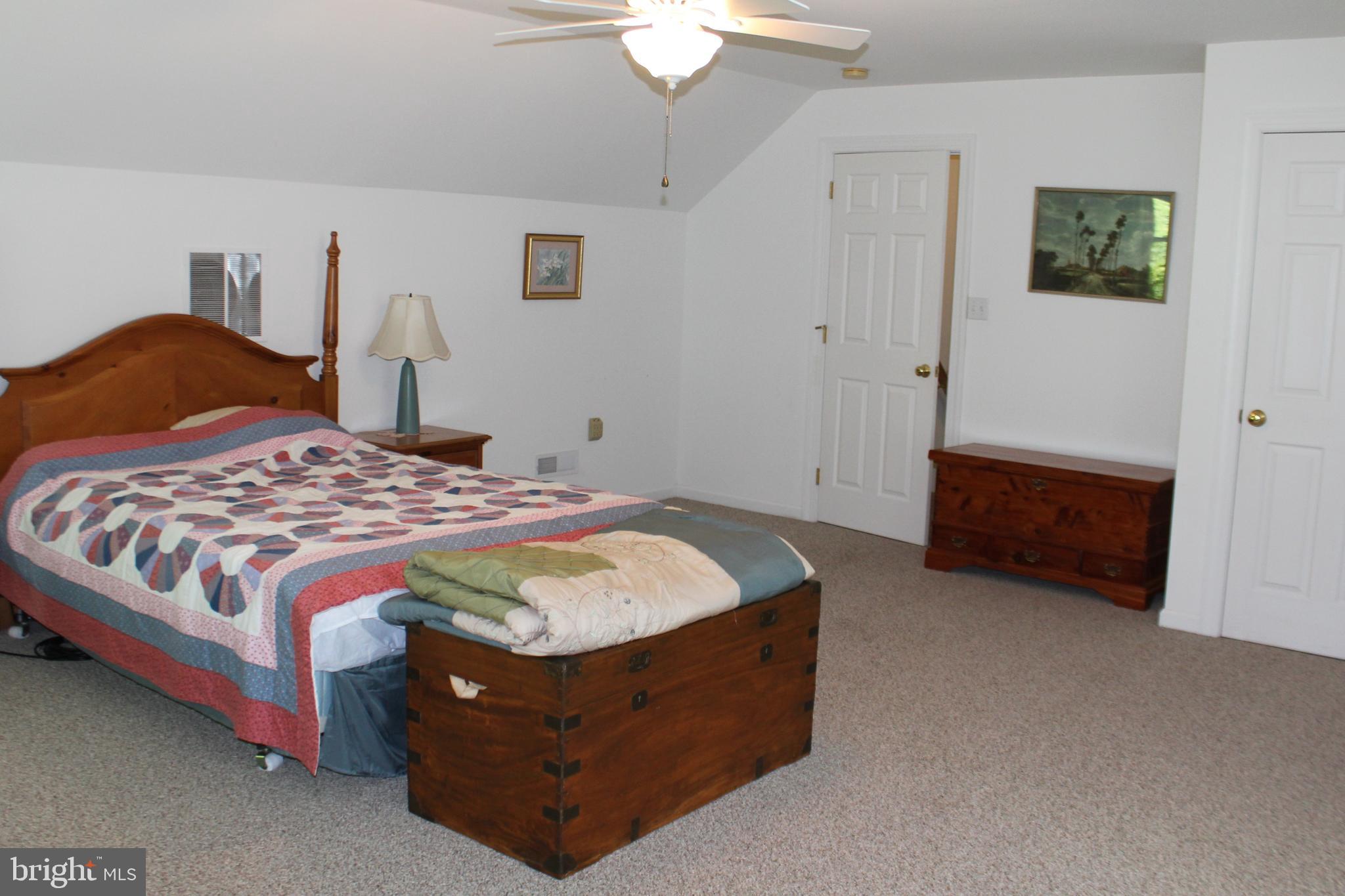 178 Shed Road Douglassville, PA 19518 - Photo 49 of 58 a spacious bedroom with a bed and a chandelier