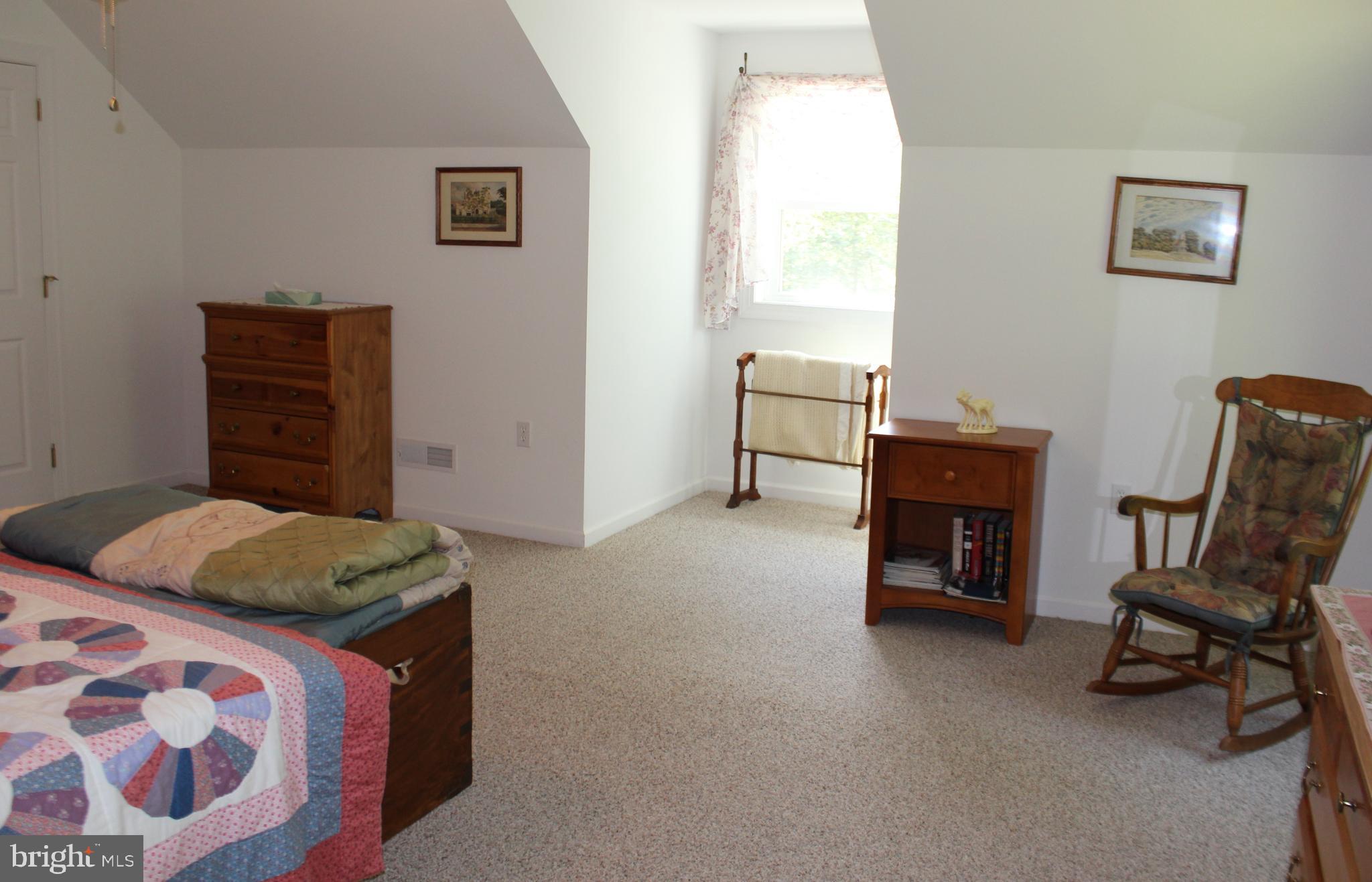 178 Shed Road Douglassville, PA 19518 - Photo 50 of 58 a bedroom with a bed and a chair