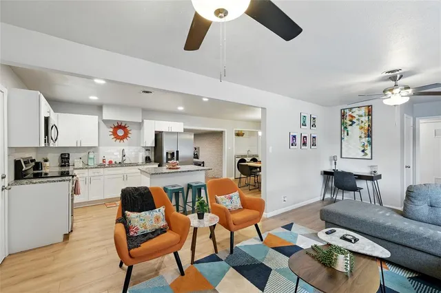 a living room with furniture and kitchen view
