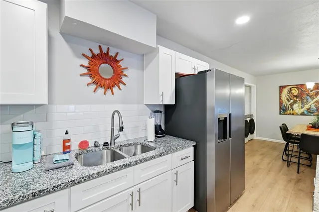 a kitchen with a refrigerator and sink