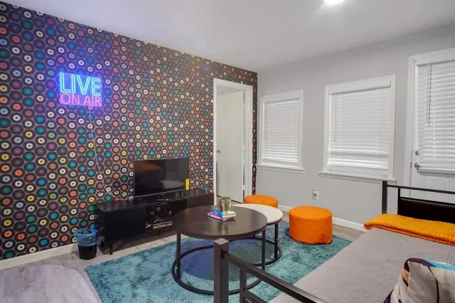 a living room with furniture a flat screen tv and a fireplace