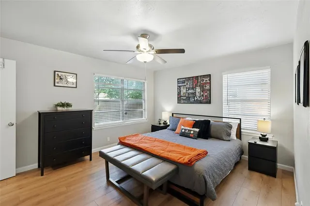 a bedroom with a bed and wooden floor