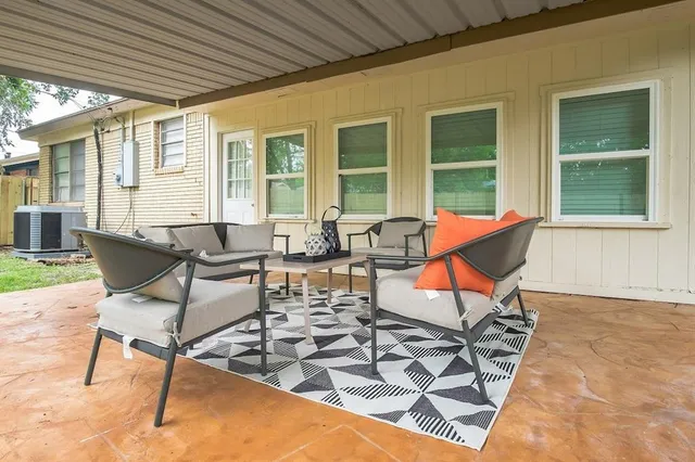 a building outdoor space with patio furniture and wooden floor