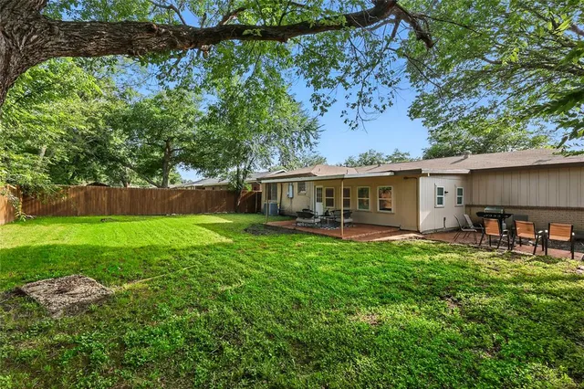 a front view of house with a garden