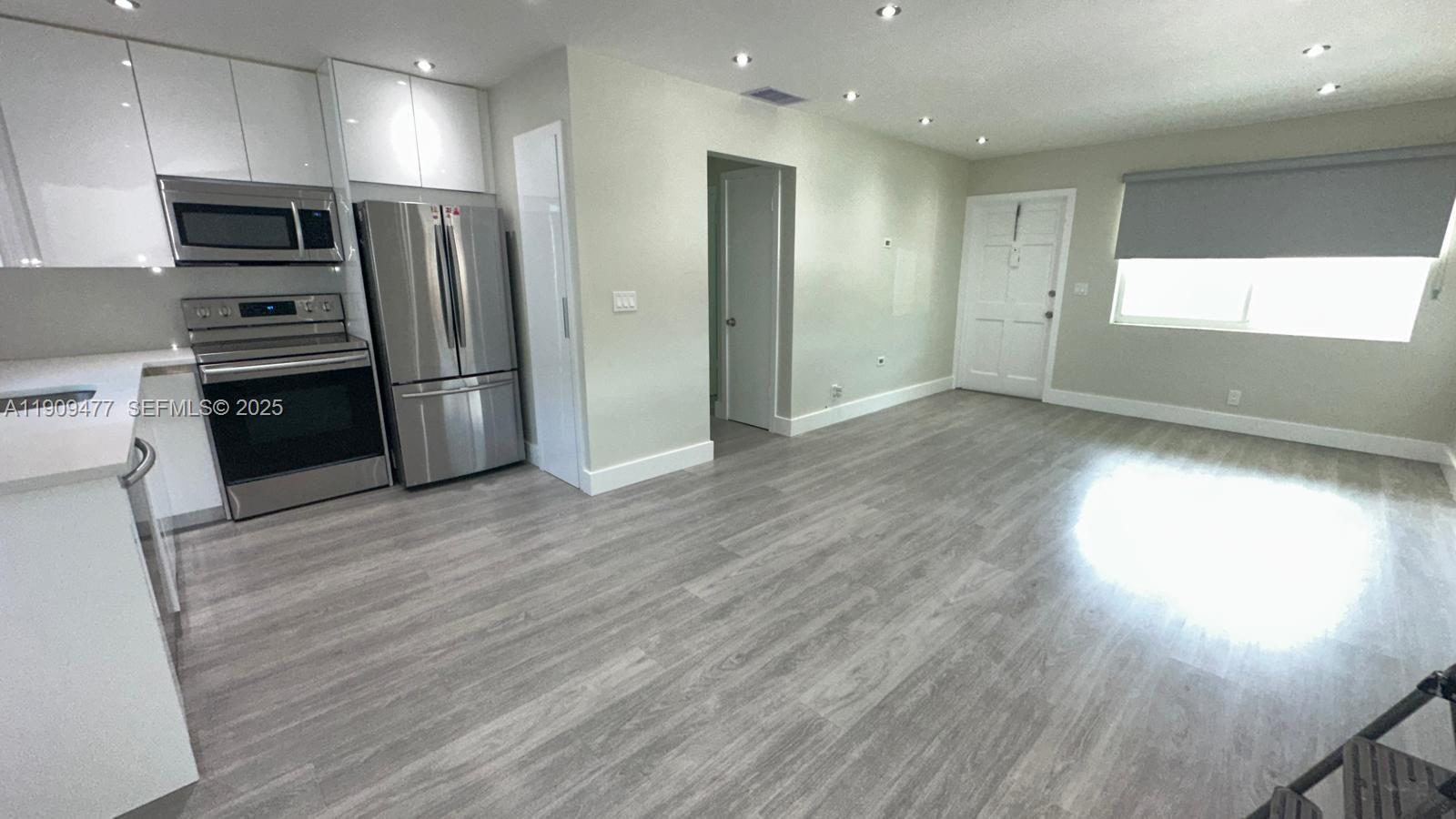 a kitchen with stainless steel appliances a refrigerator and a stove top oven