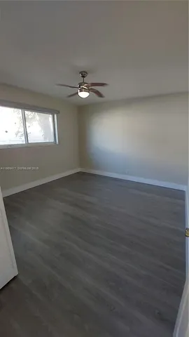 a view of a room with wooden floor and windows