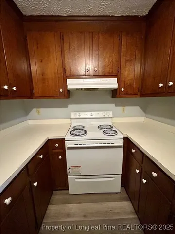 a stove top oven sitting inside of a kitchen