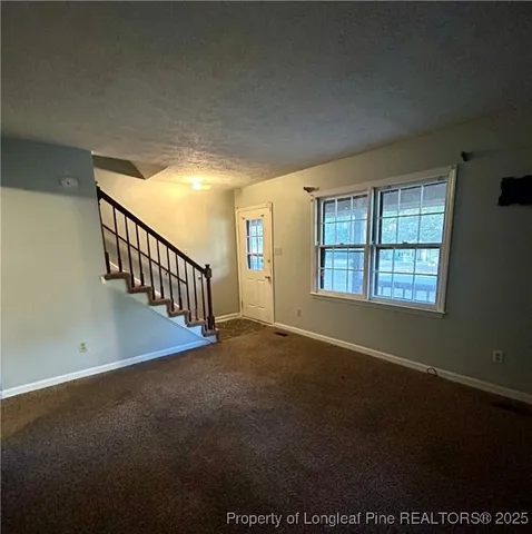 a view of an empty room with windows