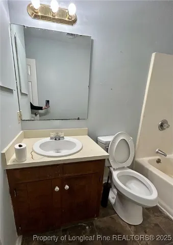 a bathroom with a sink toilet and mirror