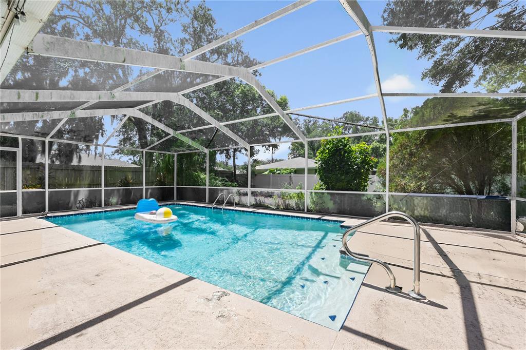 8453 Apple Orchard Road Spring Hill, FL 34608 - Photo 11 of 66 a view of a backyard with table and chairs