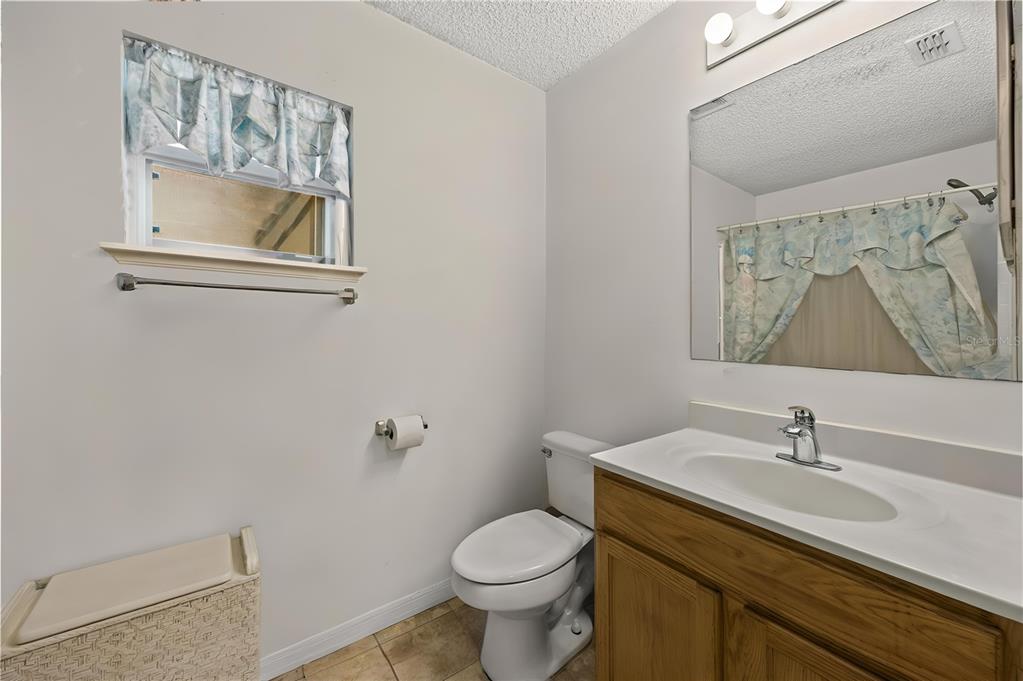 8453 Apple Orchard Road Spring Hill, FL 34608 - Photo 24 of 66 a bathroom with a toilet sink and mirror
