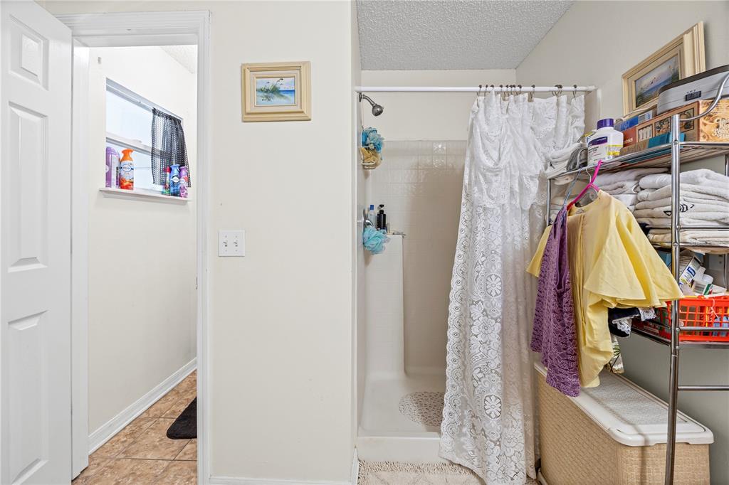 8453 Apple Orchard Road Spring Hill, FL 34608 - Photo 31 of 66 a view of walk in closet with clothes and shoes