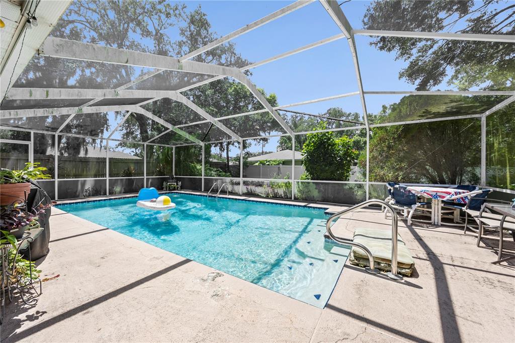 8453 Apple Orchard Road Spring Hill, FL 34608 - Photo 35 of 66 a view of a chair and table in patio
