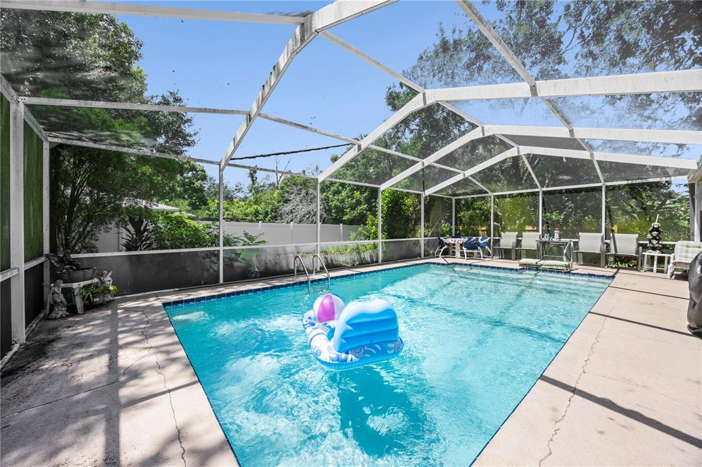 8453 Apple Orchard Road Spring Hill, FL 34608 - Photo 38 of 66 a view of a swimming pool with a patio
