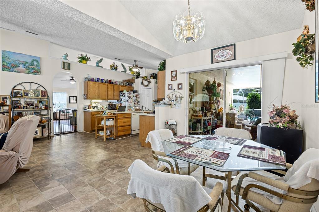 8453 Apple Orchard Road Spring Hill, FL 34608 - Photo 42 of 66 a view of a dining room with furniture and a chandelier