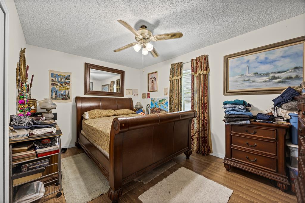 8453 Apple Orchard Road Spring Hill, FL 34608 - Photo 45 of 66 a bedroom with a bed and a painting on the wall