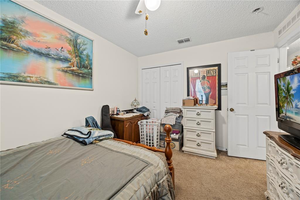 8453 Apple Orchard Road Spring Hill, FL 34608 - Photo 48 of 66 a bedroom with furniture and a flat screen tv