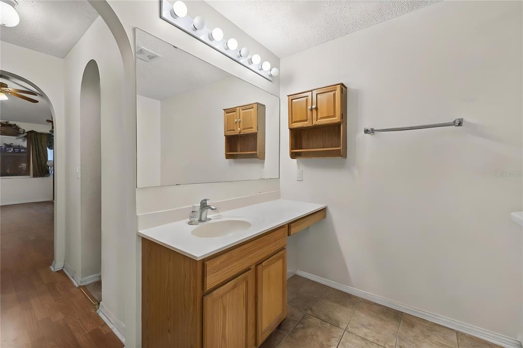 8453 Apple Orchard Road Spring Hill, FL 34608 - Photo 5 of 66 a bathroom with a sink and a mirror