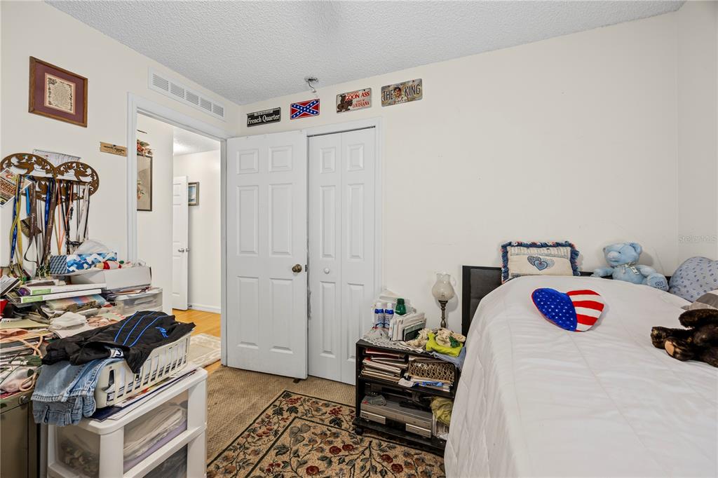 8453 Apple Orchard Road Spring Hill, FL 34608 - Photo 51 of 66 a bedroom with a bed and wooden floor