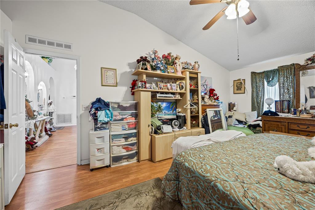 8453 Apple Orchard Road Spring Hill, FL 34608 - Photo 53 of 66 a bed room with a bed mirror and a desk
