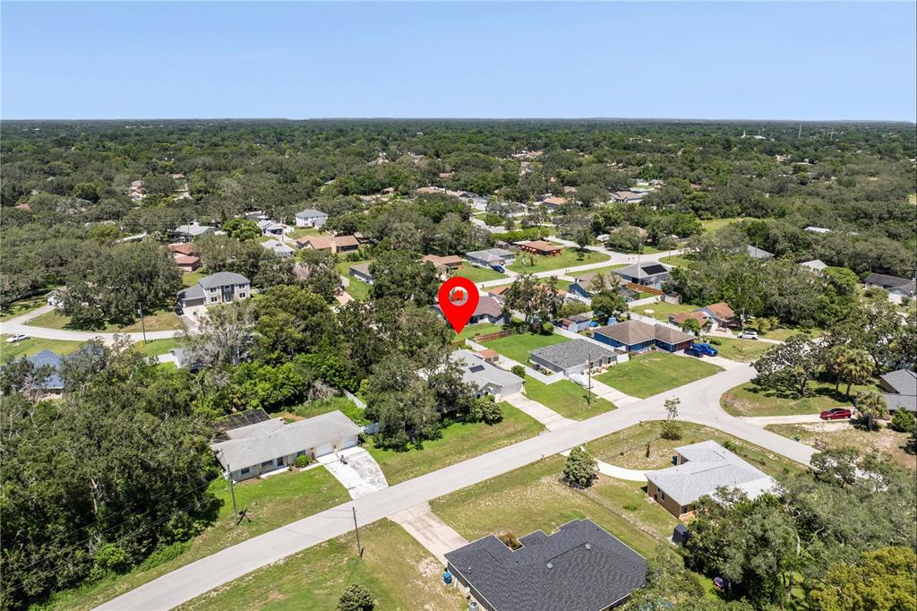 8453 Apple Orchard Road Spring Hill, FL 34608 - Photo 62 of 66 an aerial view of residential houses with outdoor space and trees
