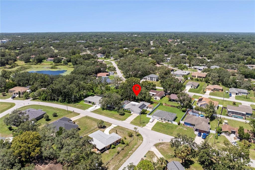 8453 Apple Orchard Road Spring Hill, FL 34608 - Photo 63 of 66 an aerial view of residential houses with outdoor space and trees