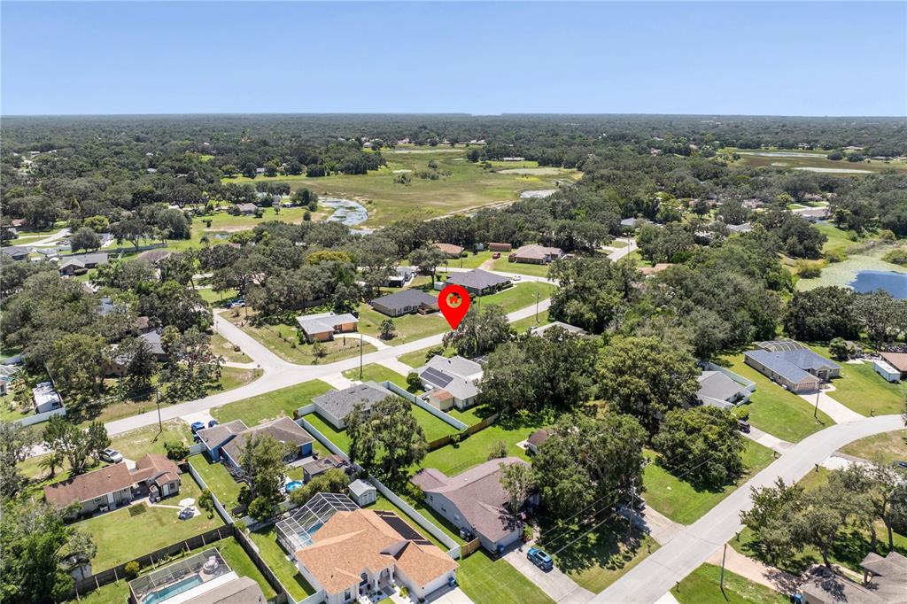 8453 Apple Orchard Road Spring Hill, FL 34608 - Photo 64 of 66 an aerial view of residential houses with outdoor space and ocean view