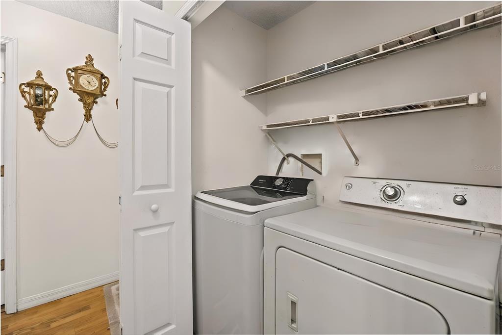 8453 Apple Orchard Road Spring Hill, FL 34608 - Photo 8 of 66 a view of storage and utility room with washer and dryer