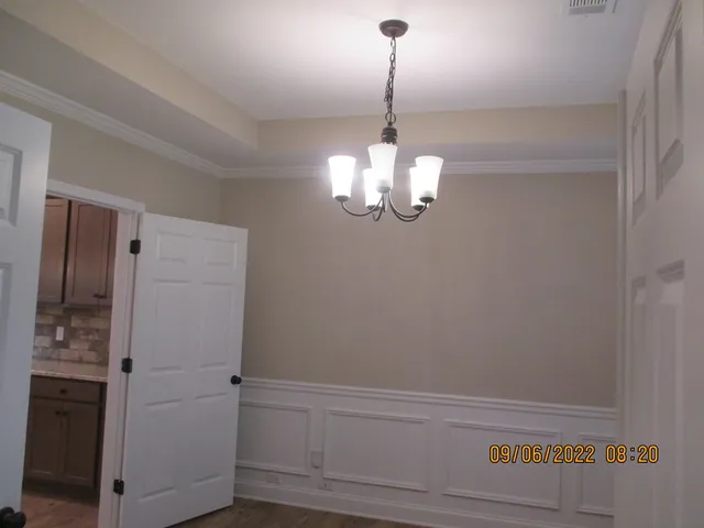a view of a hallway with a refrigerator