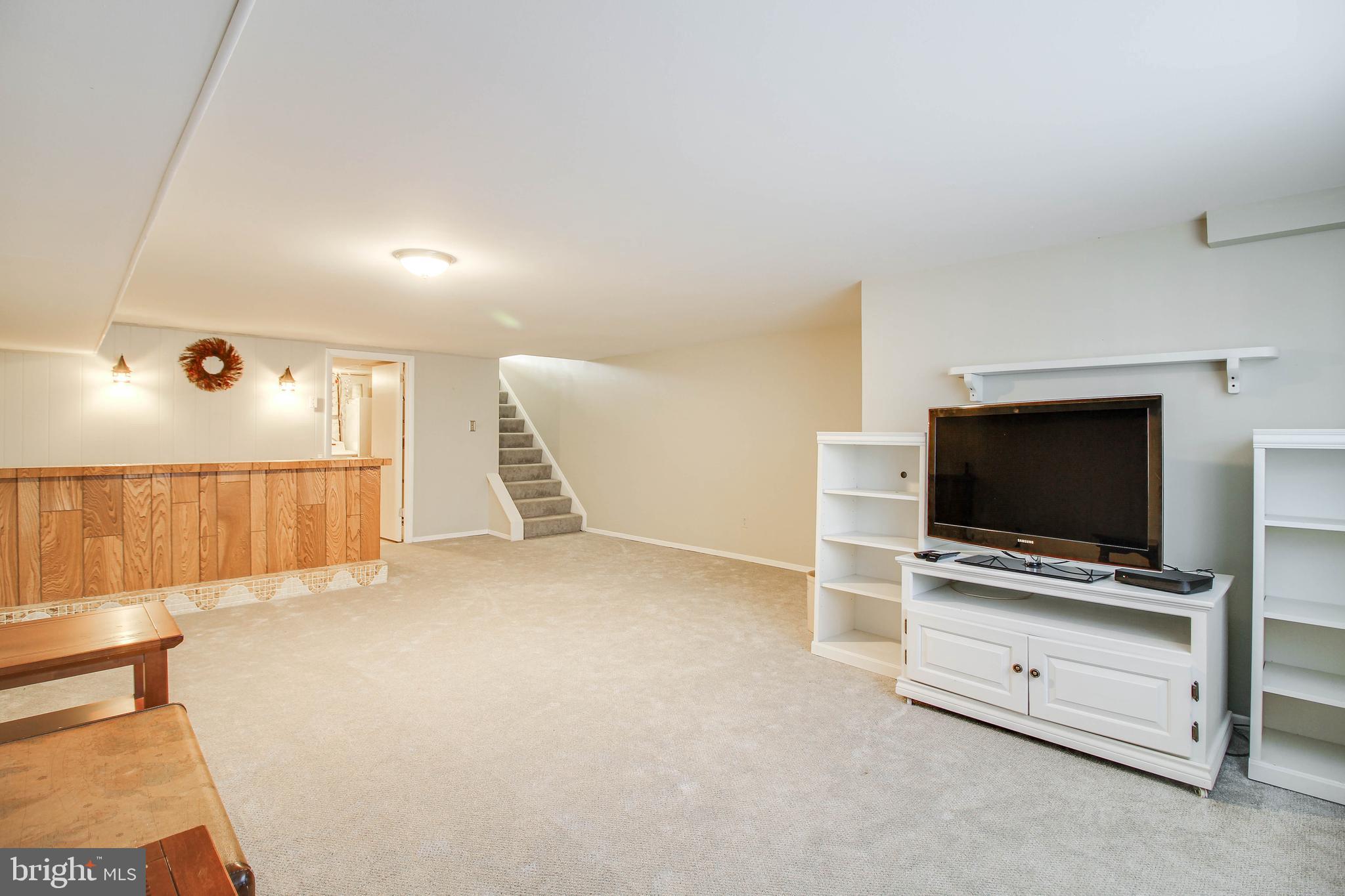 5649 Chelwynd Road Halethorpe, MD 21227 - Photo 30 of 44 a living room with furniture and flat screen tv