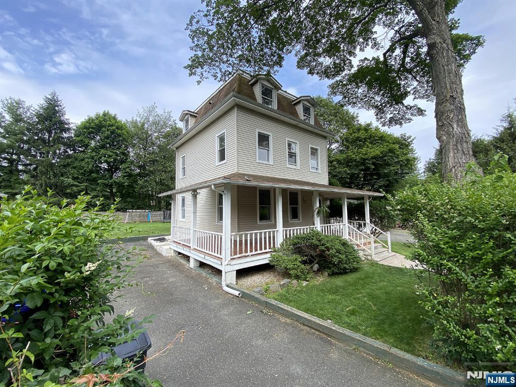 59 Forest Street Alpine, NJ 07620 - Photo 2 of 16 a view of a house with a yard and plants