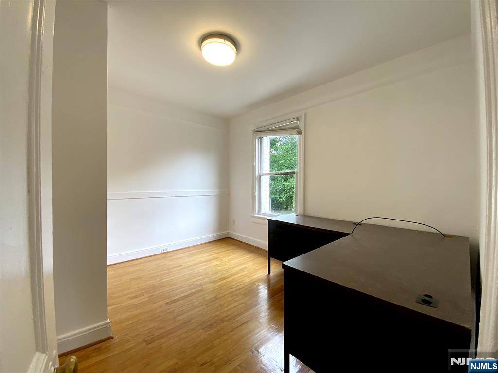 59 Forest Street Alpine, NJ 07620 - Photo 10 of 16 an empty room with wooden floor and windows