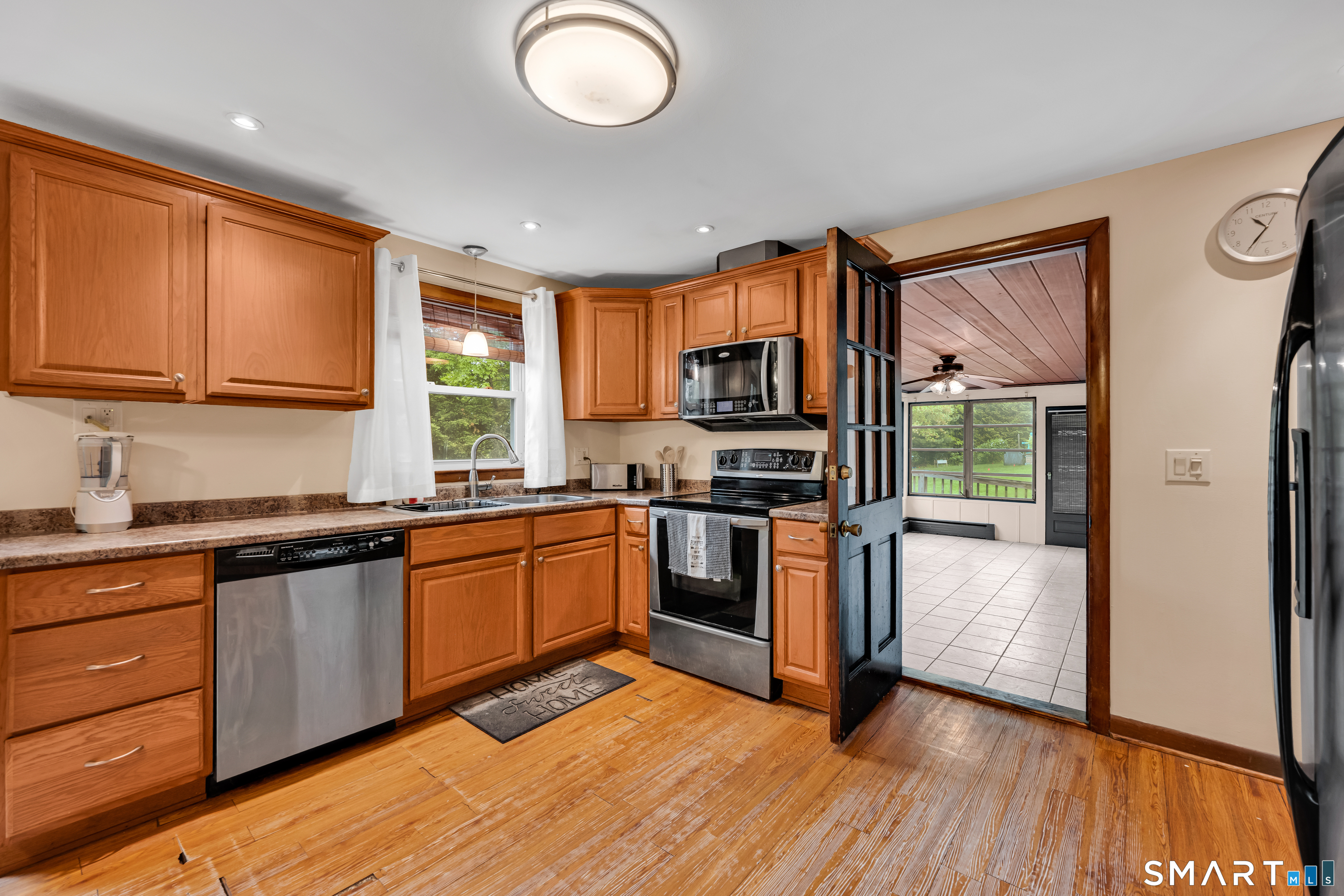 85 Timothy Road Naugatuck, CT 06770 - Photo 8 of 30 a kitchen with stainless steel appliances granite countertop a stove top oven a sink dishwasher and a refrigerator with wooden floor