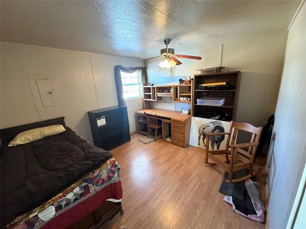a bedroom with furniture and a wooden floor