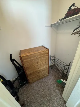 a view of room with clothes and shoes
