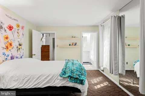 a bedroom with a bed and a view of bathroom
