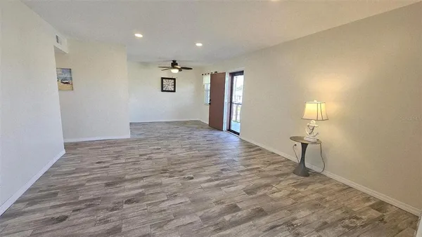 a view of empty room with wooden floor