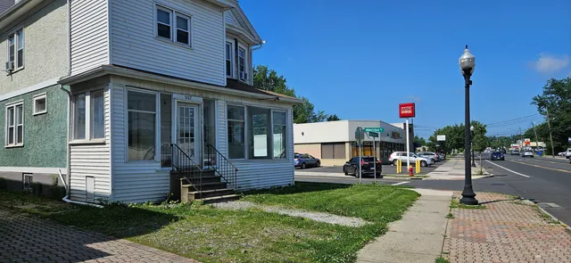 a view of a house with sitting area and garden