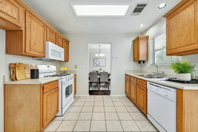 a kitchen with stainless steel appliances granite countertop a sink and cabinets