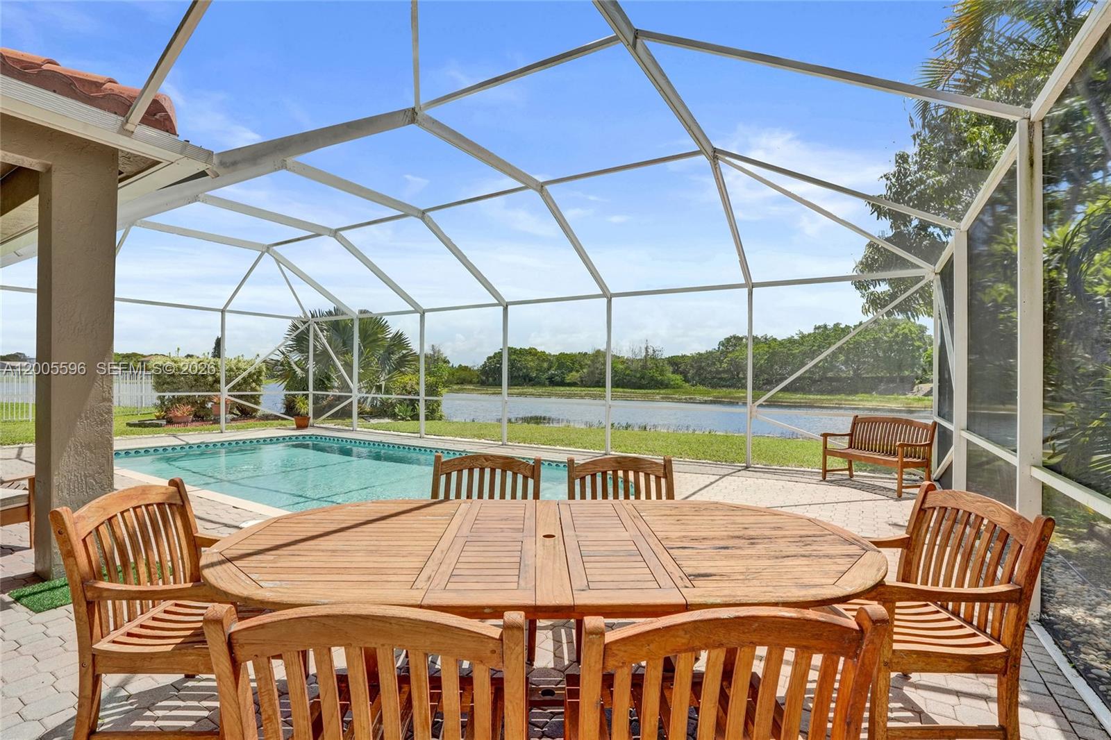 4281 Laurel Ridge Circle Weston, FL 33331 - Photo 37 of 80 a view of a patio with a table chairs and a backyard