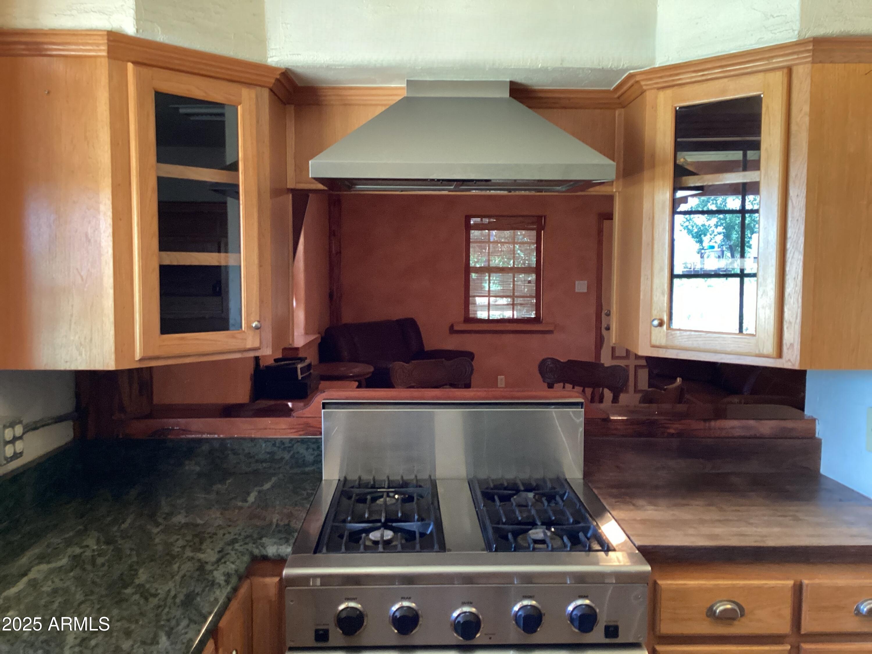 10023 North Bell Road Elfrida, AZ 85610 - Photo 11 of 51 a kitchen with stainless steel appliances granite countertop a stove and a sink