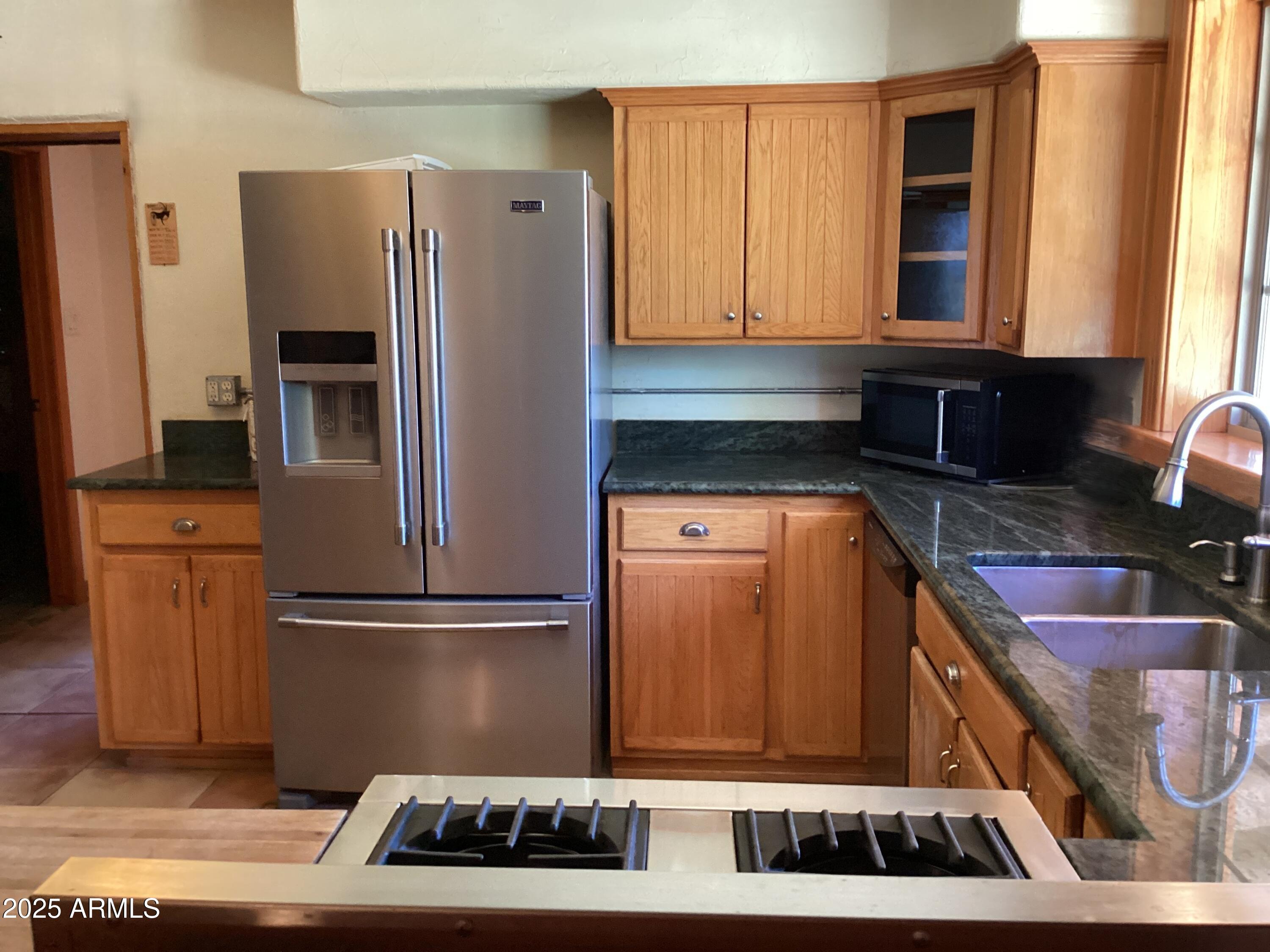 10023 North Bell Road Elfrida, AZ 85610 - Photo 12 of 51 a kitchen with refrigerator and window